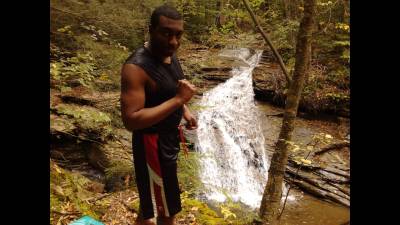 Master Xavi Poses Near A Waterfall