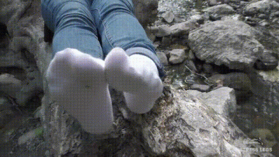 Feet In White Socks At The Waterfall
