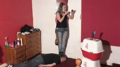 Sophie Applying Her Lip Gloss & Lip Stick Whilst Standing On Her Slaves Head In Boots