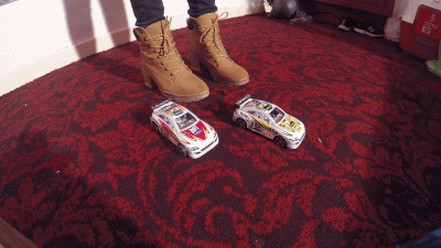 2 Model Cars Crushed Under Sophie's Boots Close Up