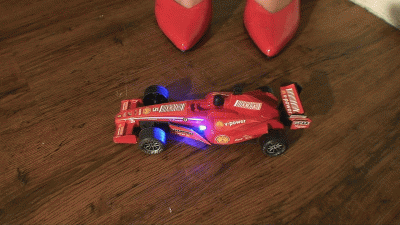 F1 Car Crushed Under Sophies Red High Heels