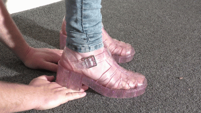 Hand Trampling In Pink Jelly Shoes Close Up