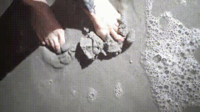 Feet Covered In Beach Sand & Water