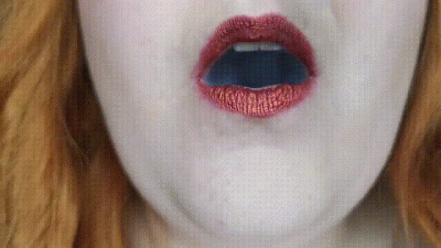 Up-Close Red Lips Blowing Smoke In Your Face