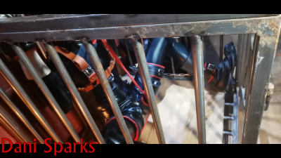 Rubber Pup In Full Steel Cage For His Milking Session