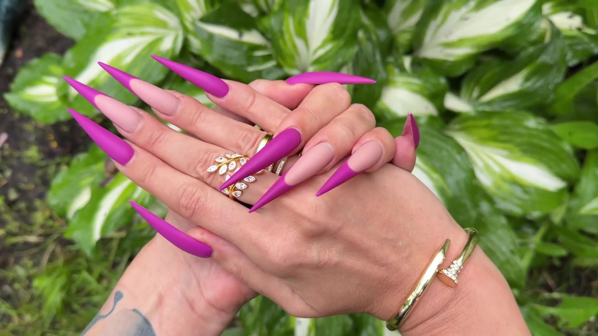 New Purple Color Long Nails, Sharp Stilettos, Palms, Long Fingers In The Garden With Flowers