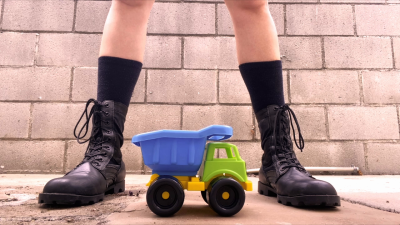 Crushing Toy Truck Combat Boots Close-Up