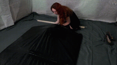 Girl In Black Dress And Small Black Vacuum Bed