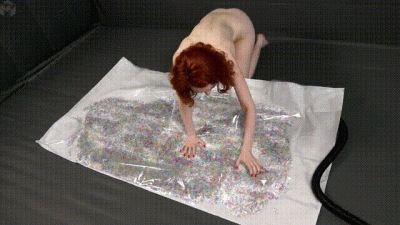 Girl Experiments With Orbeez Balls In A Vacuum Bag