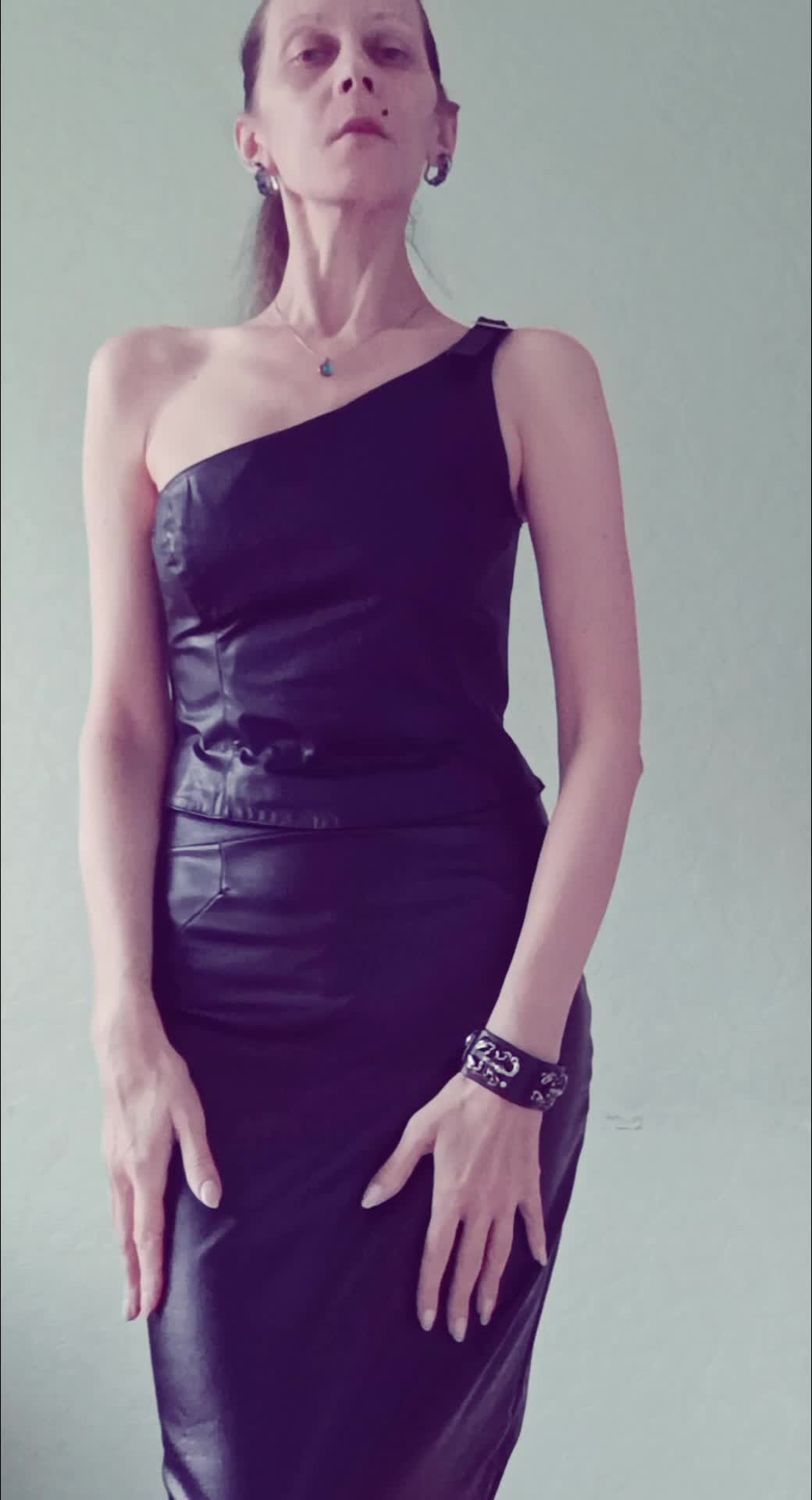Slim Domme Showing Off Her Leather Outfit