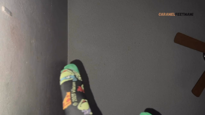 Soles & Socks Dangle Off The Bed