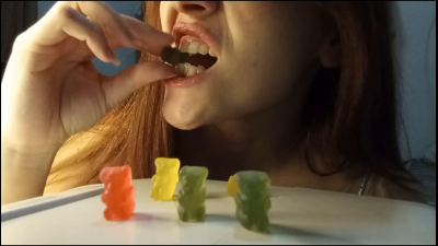 A Giant Woman Savoring And Eating Gummy Bears