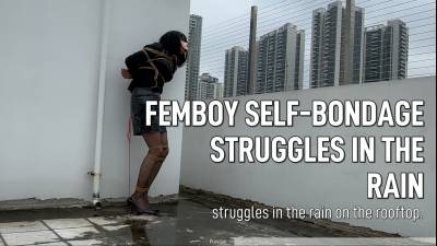 Femboy In Self-Bondage Struggles In The Rain On The Rooftop