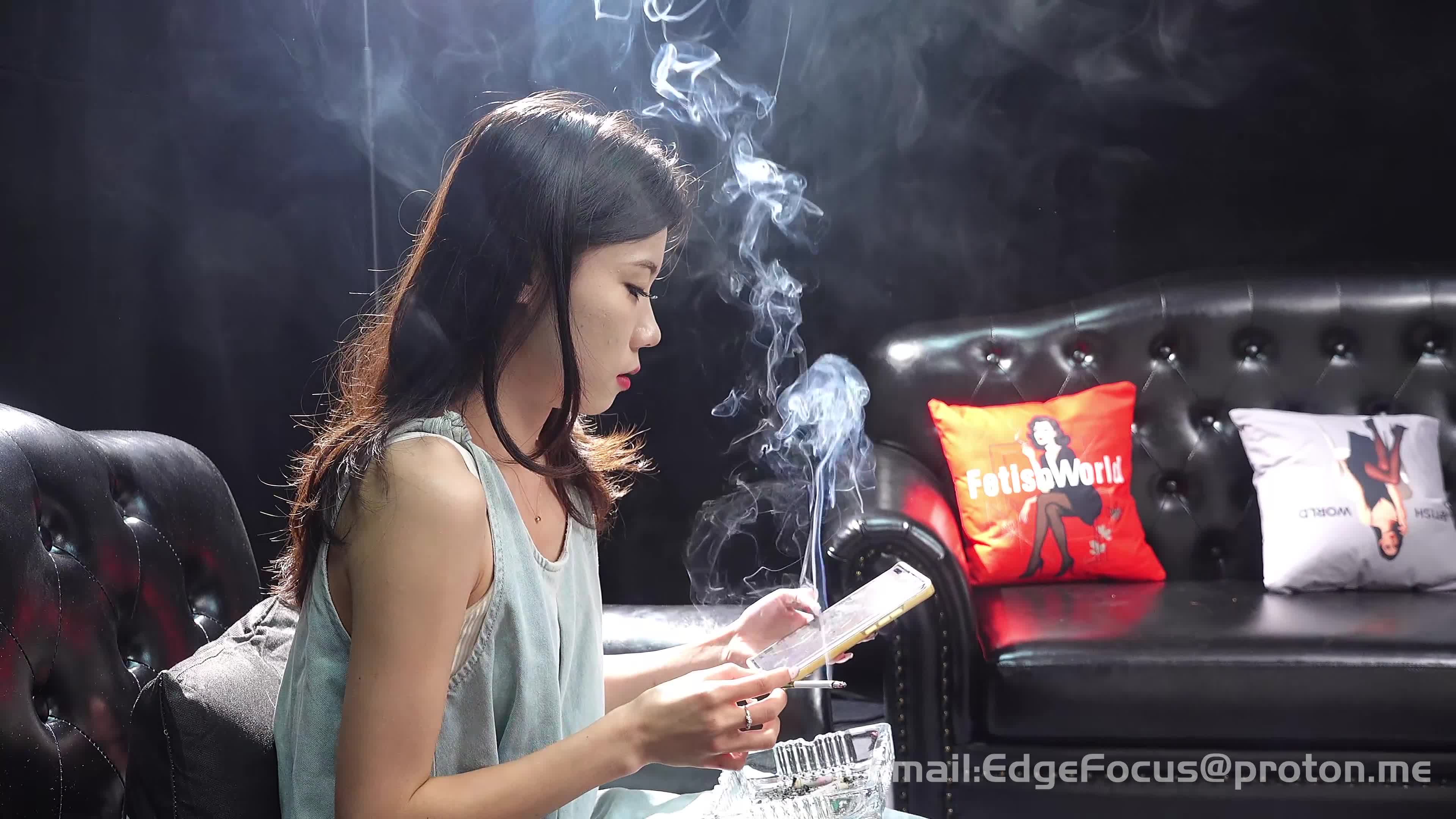Asian Woman Exhaling Thick Cigarette Smoke Clouds On Leather Couch4K