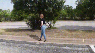 Walking Outdoors In Jeans And Black Sandals