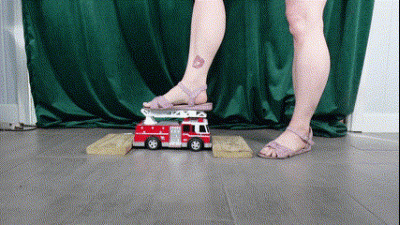 Toy Car Ambulance Crushed By Feet In Purple Sandals And Strong Calves