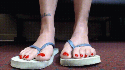 Pretty Red Toenails In Flip Flops