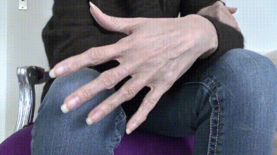 Long Natural Fingernails Close-Up On Jeans Legs