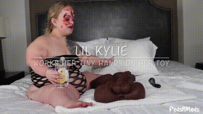 Lil Kylie Works Her Tiny Hands On Her Toy